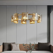 Lustra circulara cu sticla amber G9 x 9, suspendata in living modern deasupra canapelei