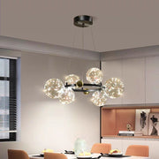 Lustra LED licurici 100W 3000K cu 15 sfere de sticla pe inel metalic negru-auriu, suspendata deasupra mesei de dining