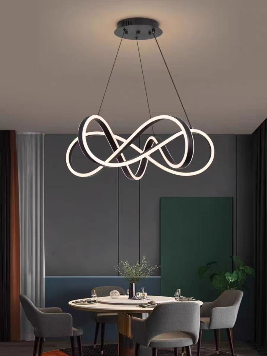 Lustra LED tip bucla dubla suspendata deasupra mesei rotunde, atmosfera calda in dining modern